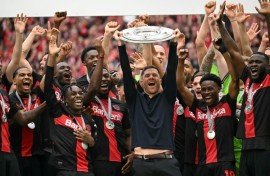 Champions: Bayer Leverkusen coach Xabi Alonso and his players celebrate with the Bundesliga trophy