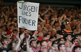 Liverpool fans hold a banner reading "Jurgen Lives Forever" 