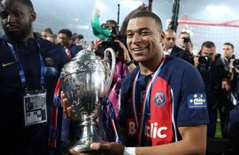 Kylian Mbappe parades the trophy after PSG beat Lyon 2-1 in Saturday's French Cup final 