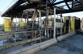 The clash at a motorway toll gate left a supporters' coach burnt out