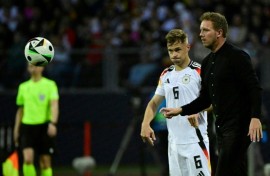 Germany's head coach Julian Nagelsmann (r), flanked by  veteran defender Joshua Kimmich, gives directions against Ukraine 