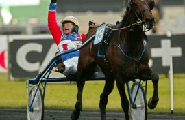 (FILES) Italian jockey Giampaulo Minucci celebrates his victory as he drives trotter 'Varenne' during the Prix D'Amerique legend race at Vincennes racetrack, outside Paris, on January 27, 2002