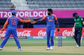 India's Hardik Pandya (C) celebrates with Virat Kohli (L) after taking a wicket in a T20 World Cup match against Ireland in New York