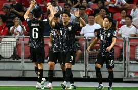 South Korea's Joo Min-kyu (centre) celebrates scoring against Singapore