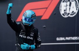Mercedes' British driver George Russell celebrates winning pole for the Canada Grand Prix 