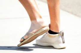 Two-time major winner Jon Rahm of Spain shows off the flip-flop he wore Tuesday at Pinehurst because of a left foot infection that has him questionable for playing in this week's 124th US Open