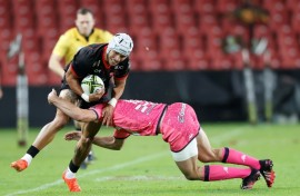 Lions wing Edwill van der Merwe (L) is tackled during a European Challenge Cup against Stade Francais in Johannesburg.
