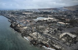 An aerial image shows Old Lahaina Center and Foodland Lahaina standing amongst destroyed homes and businesses along Front Street burned to the ground in the historic Lahaina in the aftermath of wildfires in western Maui in Lahaina, Hawaii 