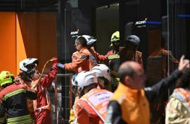 Firefighters at an incident at McLaren's hospitality unit before third practice
