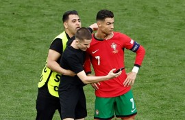 A pitch invader takes a selfie with Cristiano Ronaldo 