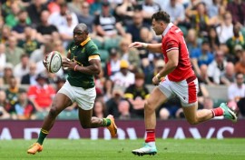 On the attack: South Africa wing Makazole Mapimpi takes on Wales centre Mason Grady at Twickenham 
