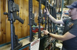 Dordon Brack pulls a semi-automatic AR-15 off the rack at Good Guys Guns & Range on February 15, 2018 in Orem, Utah