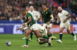 Manie Libbok (L) seeks possession for South Africa in a 2023 Rugby World Cup semi-final victory over England in Paris