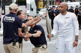 Former Arsenal and France footballer Thierry Henry, the coach of the male French Olympic team, was the first torchbearer 