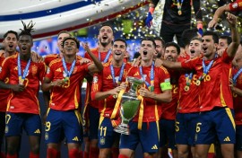 Spain's players celebrate with the Euro 2024 trophy