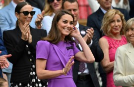 Catherine, Princess of Wales, waves as she takes her seat on Wimbledon's Centre Court 
