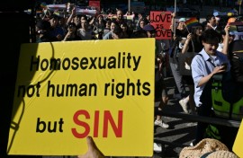 LGBTQ supporters march past anti-gay activists during the annual Pride Parade in Seoul in June