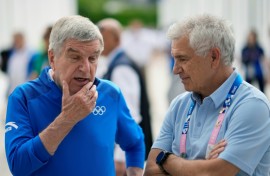 International Olympic Committee President Thomas Bach speaks to IOC member Juan Antonio Samaranch Junior at the Athletes' Village