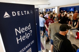 Travelers wait in line at the airport in Los Angeles, California on July 19, 2024 following a global IT crash that hobbled airlines, banks, broadcasters and other businesses