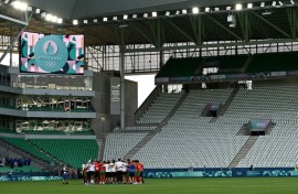 Empty feeling: Morocco's players and staff celebrate at the end of the match with Argentina