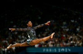 Simone Biles competes in floor exercise in women's gymnastics qualifying at the Paris Olympics