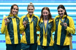 Gold medallists Australia pose with their medals following the women's 4x100m freestyle relay