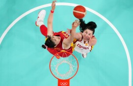 Spain's Megan Gustafson  and China's Li Yueru go for a rebound in basketball