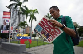 A man reads a newspaper in Caracas on July 29, 2024, a day after the Venezuelan presidential election