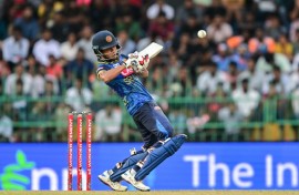Sri Lanka's Dunith Wellalage plays a shot during the first one-day international (ODI) cricket match between Sri Lanka and India in Colombo on August 2