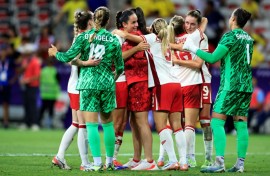 Canada's players celebrate after beating Colombia to qualify for the quarter-finals at the Olympics
