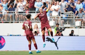 Manchester City forward Erling Haaland, right, celebrates after scoring his second goal against Chelsea in a pre-season English club friendly at Columbus, Ohio