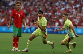 Juanlu Sanchez (C) celebrates with Fermin Lopez after scoring Spain's winning goal against Morocco in their Olympic men's football semi-final