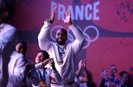 Teddy Riner and the gold medal-winning French judo team celebrate with supporters at Club France