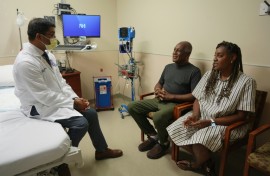 Doctor Satish Nadig (L), professor of surgery at the Northwestern University-Feinberg School of Medicine, speaks with patient, Harry Stackhouse (C), 74, and his daughter Trewaunda Stackhouse, 45, in a clinic post-transplant room at Northwestern Medicine 