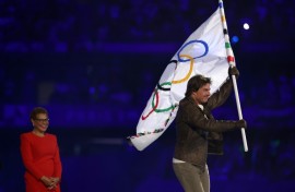 Tom Cruise takes the Olympic flag as Karen Bass, the mayor of 2028 hosts Los Angeles, looks on