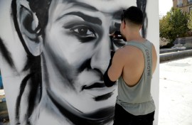 An artist paints a large portrait of Algerian Olympic boxing champion Imane Khelif in her hometown Tiaret