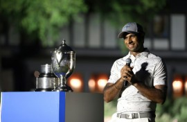 Aaron Rai of England accepts the trophy after winning his first PGA Tour title at the Wyndham Championship