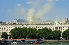 Smoke rises from a fire located in the roof of Somerset House beside the River Thames