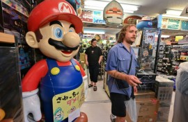 Around 70-80 percent of his customers are foreign tourists, who have flocked to Japan in record numbers this year, says the manager of a vintage video game shop