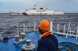 A China Coast Guard ship is seen from a Philippine Coast Guard vessel during a supply mission to Sabina Shoal earlier this month
