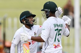 Bangladesh's Mushfiqur Rahim (L) and Shakib Al Hasan celebrate after winning the second Test