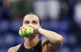 Crowd favourite: Aryna Sabalenka prepares to throw signed tennis balls to fans after defeatng Zheng Qinwen 