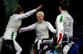 Bebe Vio (centre) congratulates her Italian teammates after winning a bronze medal in the women's wheelchair fencing