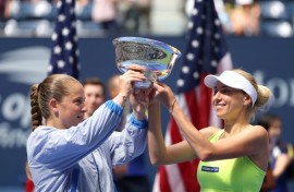 Champions: Bride-to-be Lyudmyla Kichenok (R) with Jelena Ostapenko pose with their trophy 