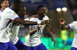 Ousmane Dembele (C) celebrates with teammates after scoring France's second goal against Belgium in Lyon