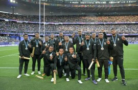The Fiji team celebrate with their silver medals at the Stade de France following defeat to France in the final of the Paris Olympics