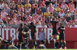 Barcelona's starlet Lamine Yamal (R) celebrates scoring his team's second goal against Girona