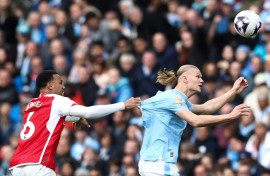 Arsenal must stop an in-form Erling Haaland (right) as the Premier League's top two face off on Sunday