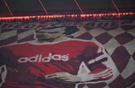 Bayern Munich fans display a banner depicting late football player Franz Beckenbauer at their Allianz Arena home