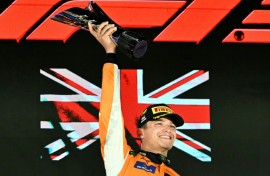 McLaren's British driver Lando Norris (C) celebrates winning on the podium after the Formula One Singapore Grand Prix